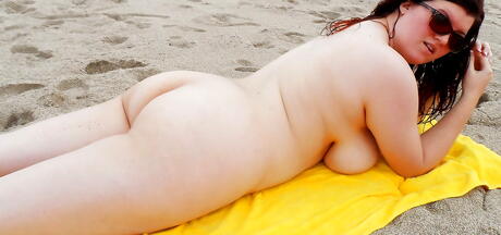 Enchanting babe Dulcinea in sexy shorts showing big knockers and ass on the beach